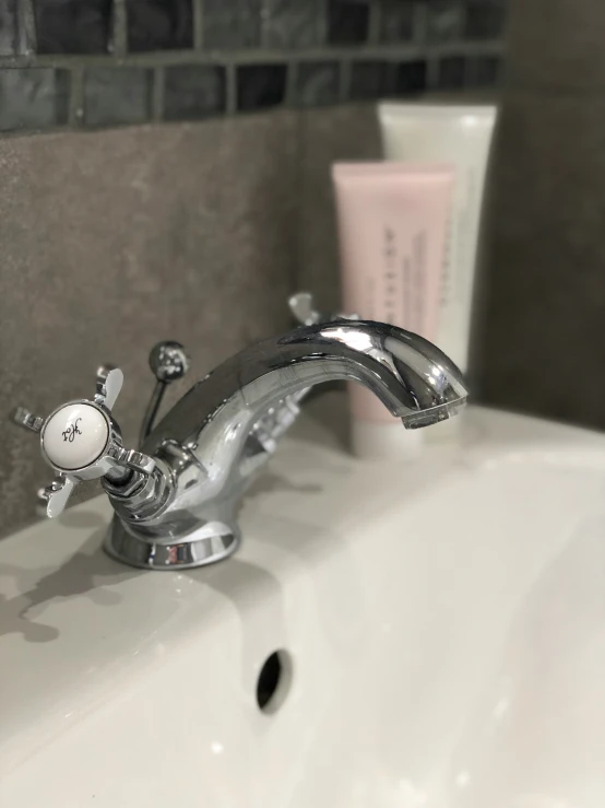 a bathroom sink with some white and pink items