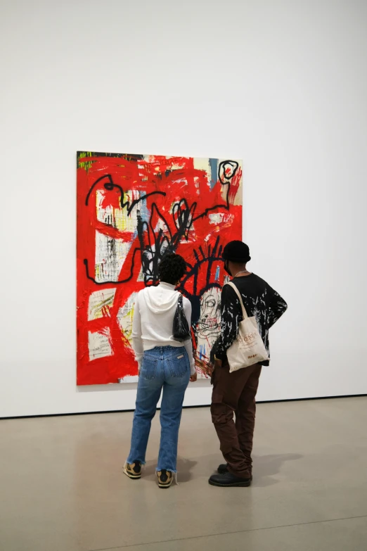 a couple of people are looking at art