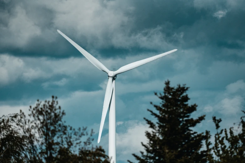 a wind turbine sitting next to some trees