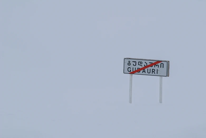 a red road sign with an upward arrow