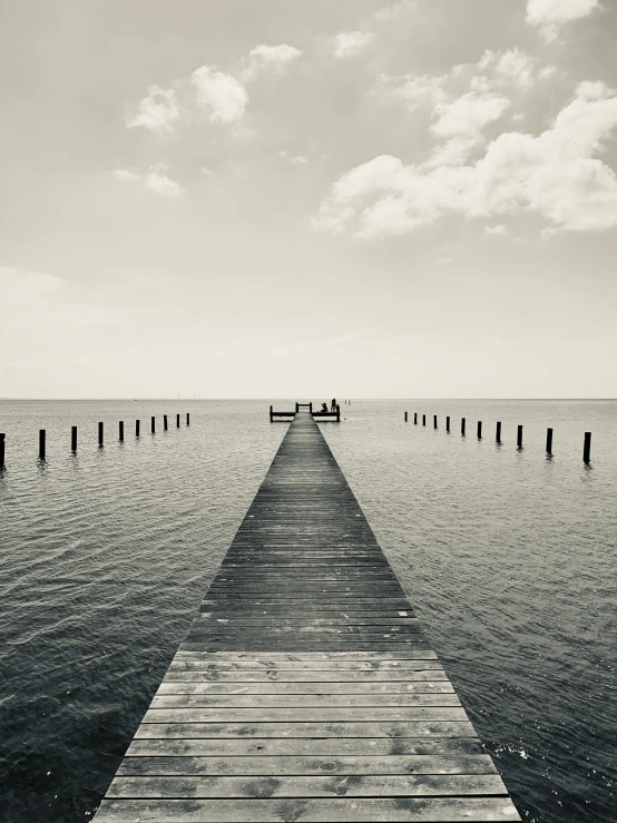 black and white pograph of the ocean at a dock