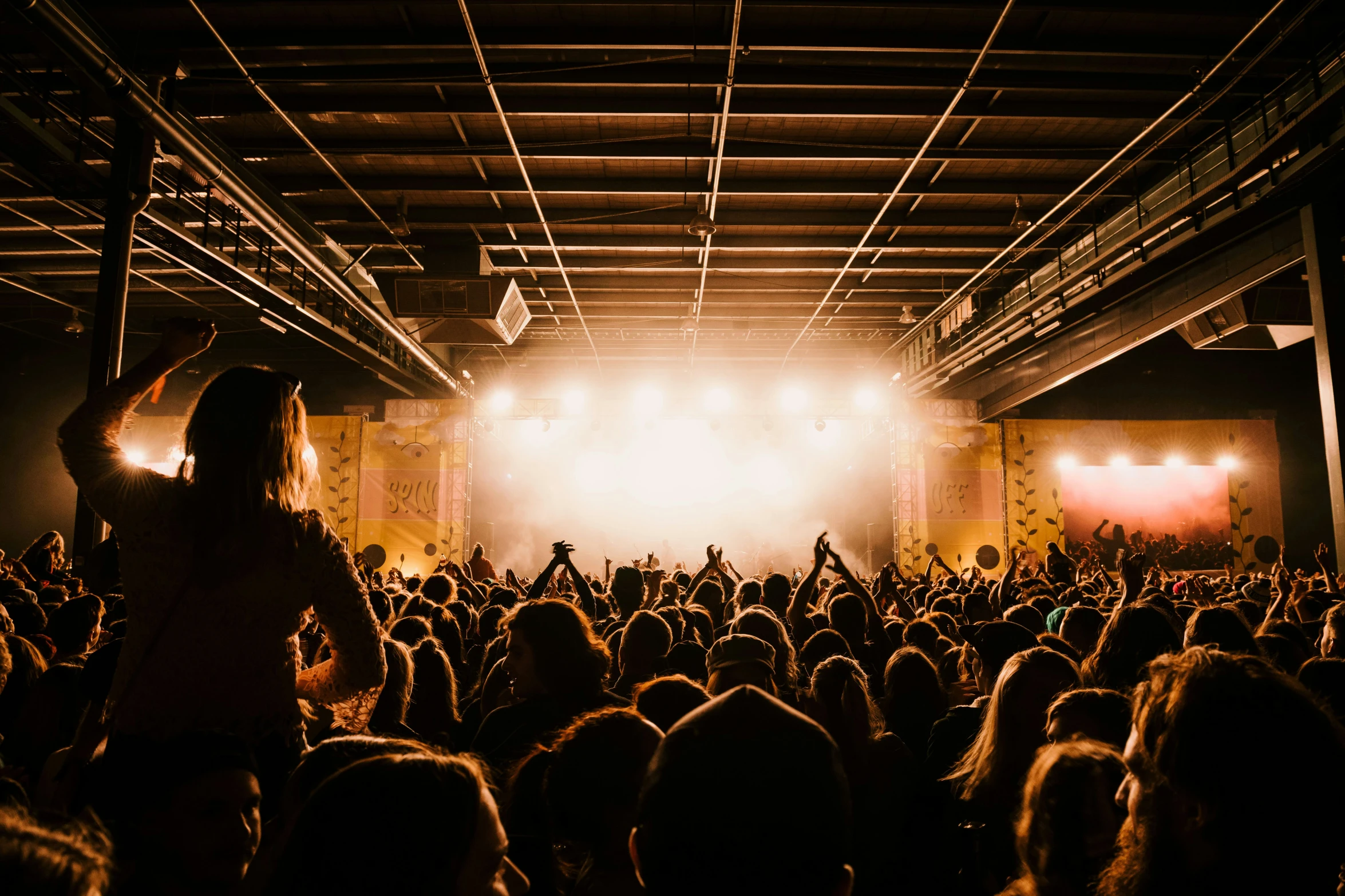 a huge crowd gathered together in a darkened room