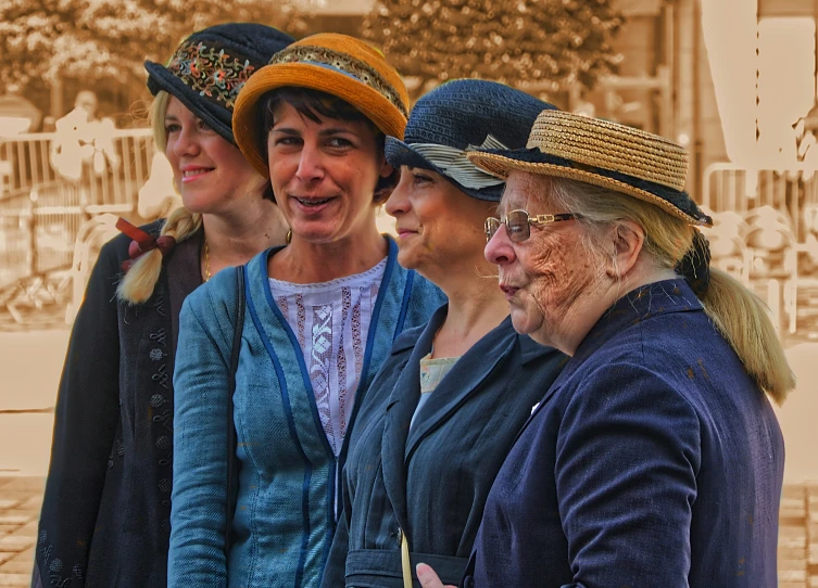 a group of women in hats, one has her mouth open