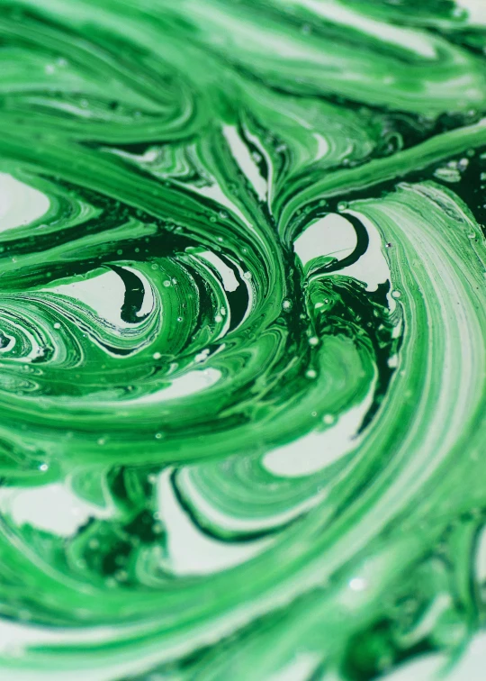 a painting with a green and white swirl on it