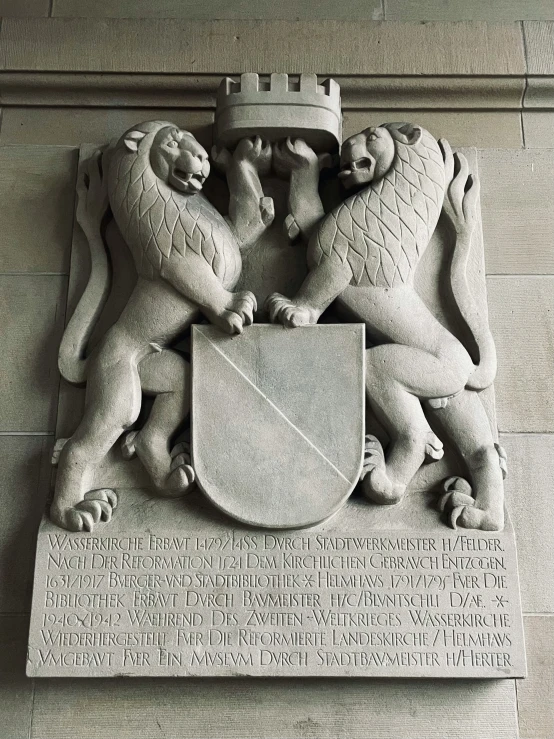 the statue shows the coat of arms, lions and a sword