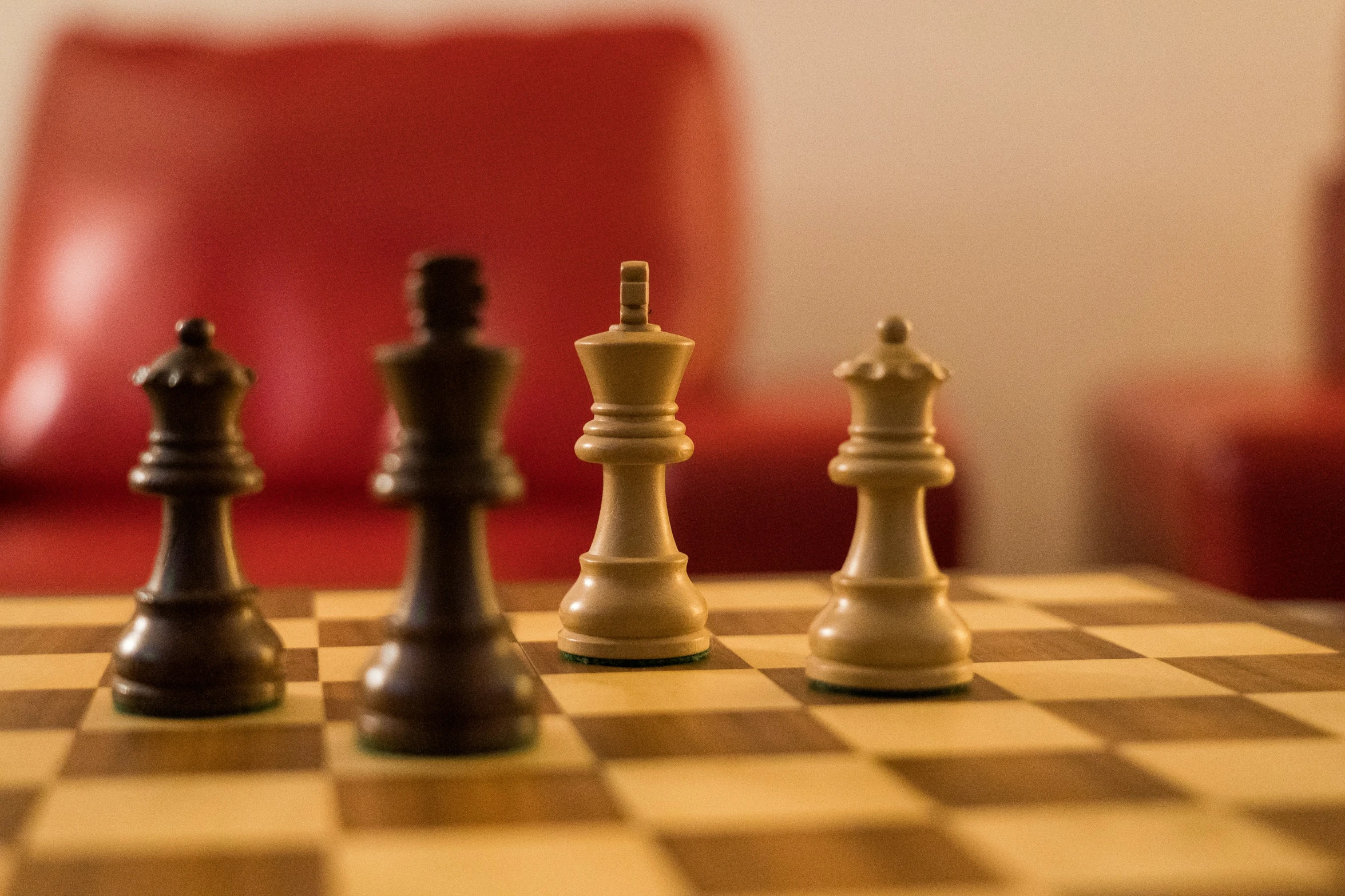 two men are standing near a chess set