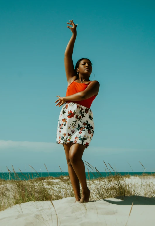 a woman in floral dress holding a flying kite