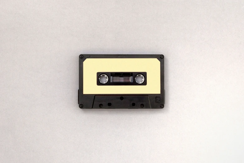 the tape cassette is a yellow piece of tape with grey ons