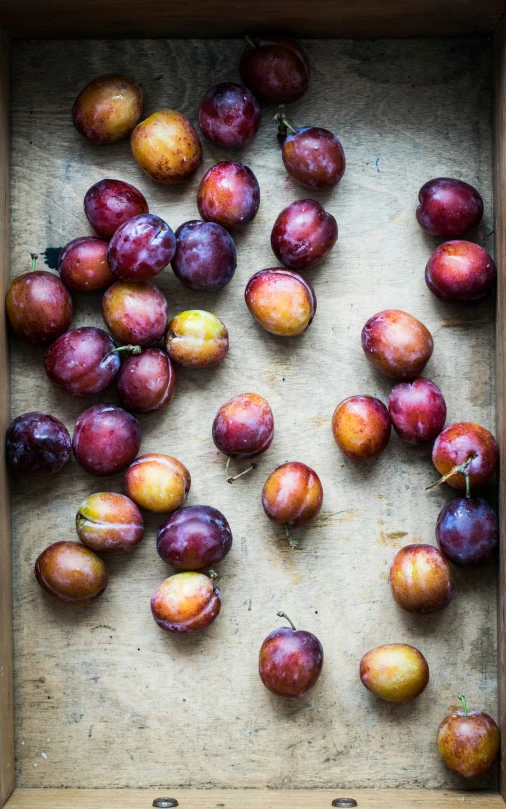 a box filled with apples on top of a table