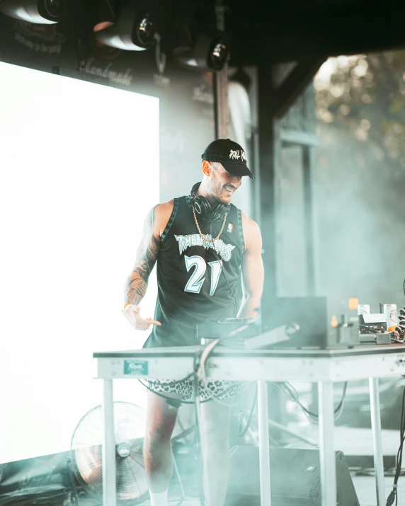 a young man is standing at a stage playing music