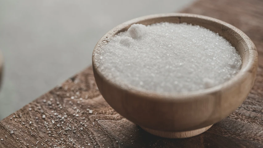 some white sugar and some spoons on top of a table