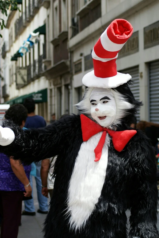 a person in cat costume holding soing up to their face
