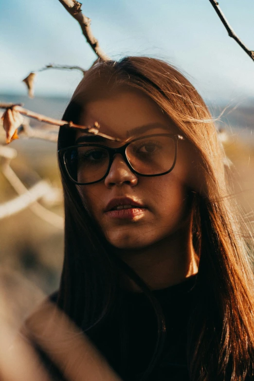 woman in glasses is staring off into the distance