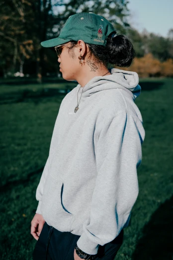 a girl wearing a hoodie in the grass