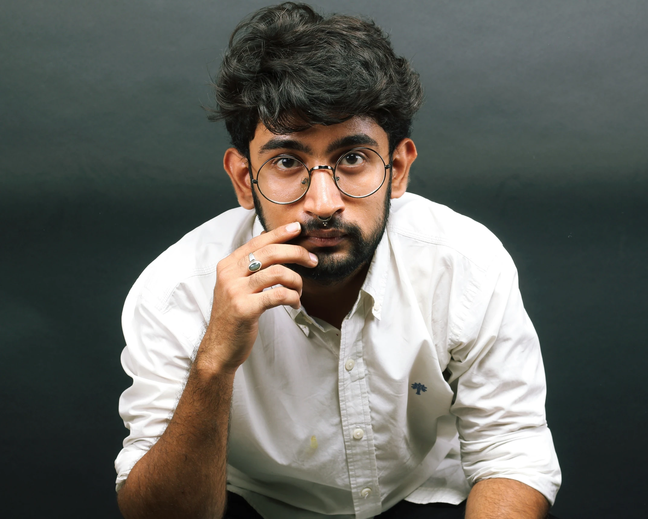 an image of a man holding his chin resting his hand on his cheek