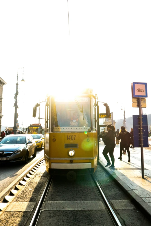 a yellow bus that is sitting on some tracks