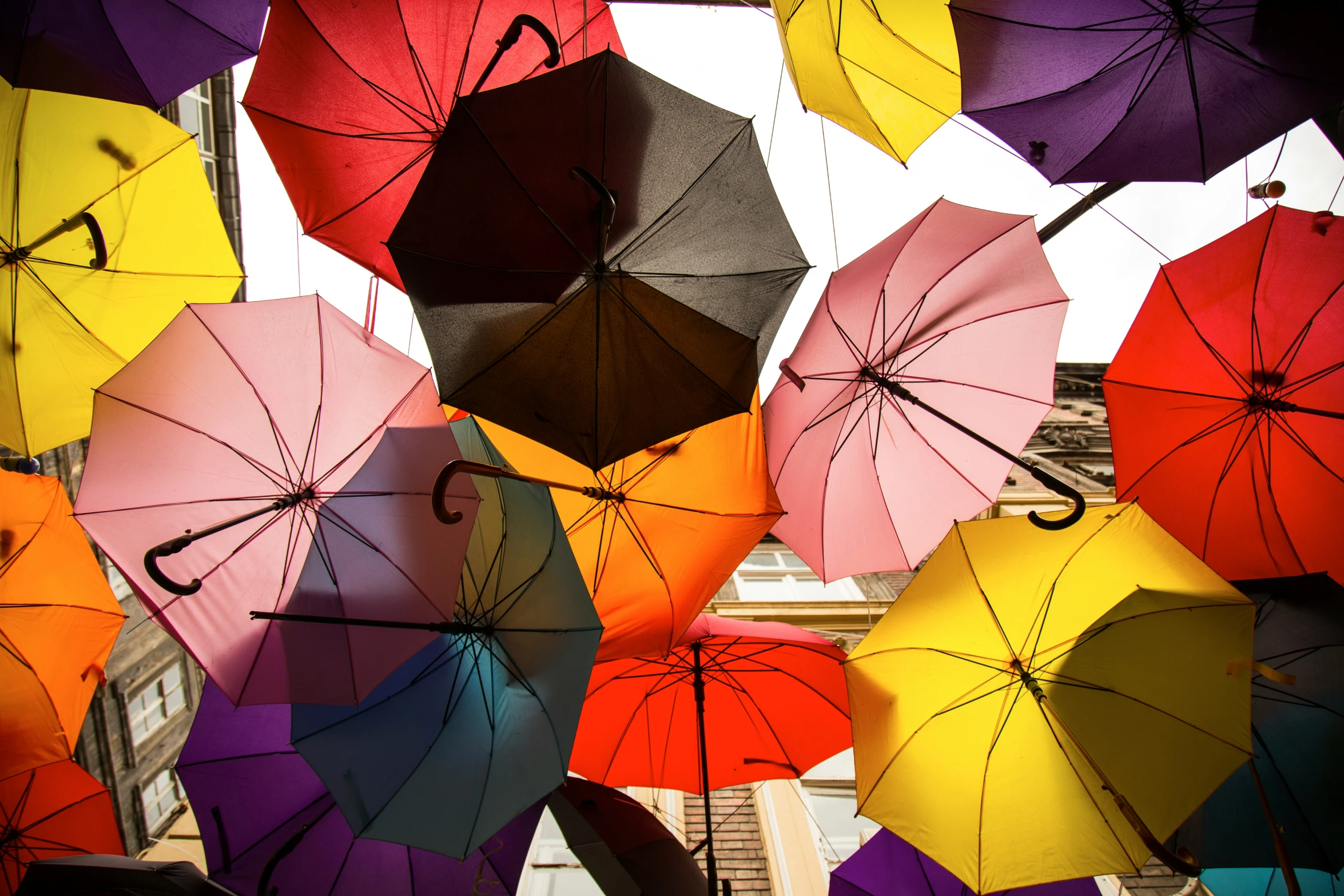 a group of colorful umbrellas that have their handles folded open