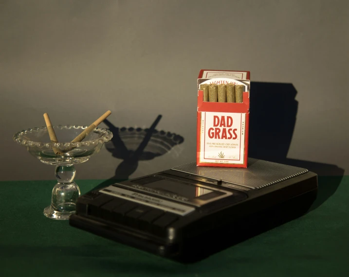 a matches on a table next to a small glass