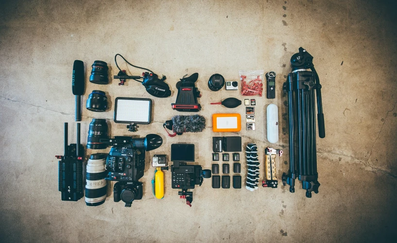 there are lots of cameras and equipment laid out on the ground