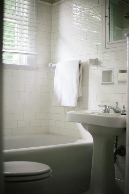 white fixtures and towels displayed in modern bathroom