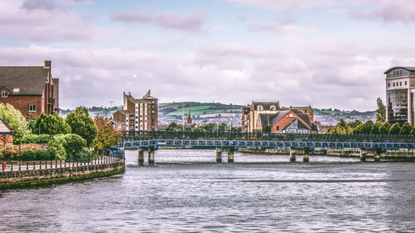 a blue bridge that has many buildings on top