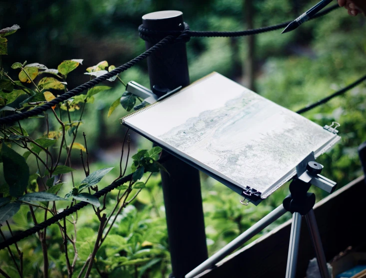 the artist's easel sits on an easel stand