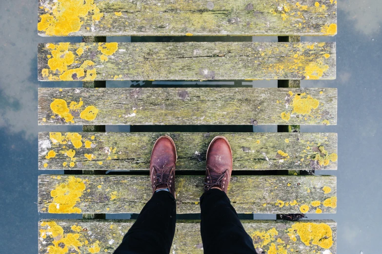 there is a man standing on the top of a bench