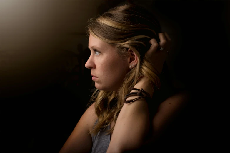 a young woman with tattoos in the dark