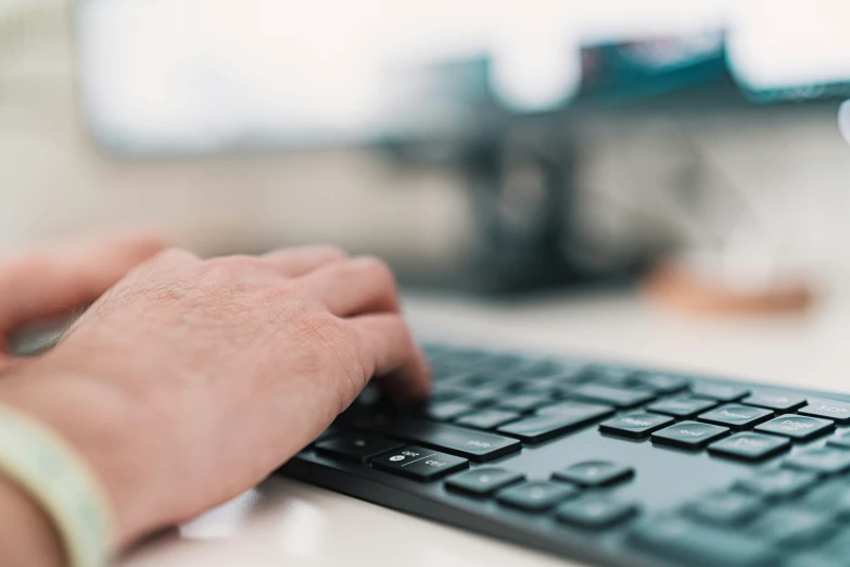 a person using a computer keyboard in a blurry image