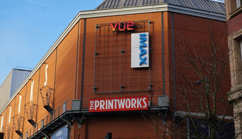 a building on the corner of a street with a large advertit on it