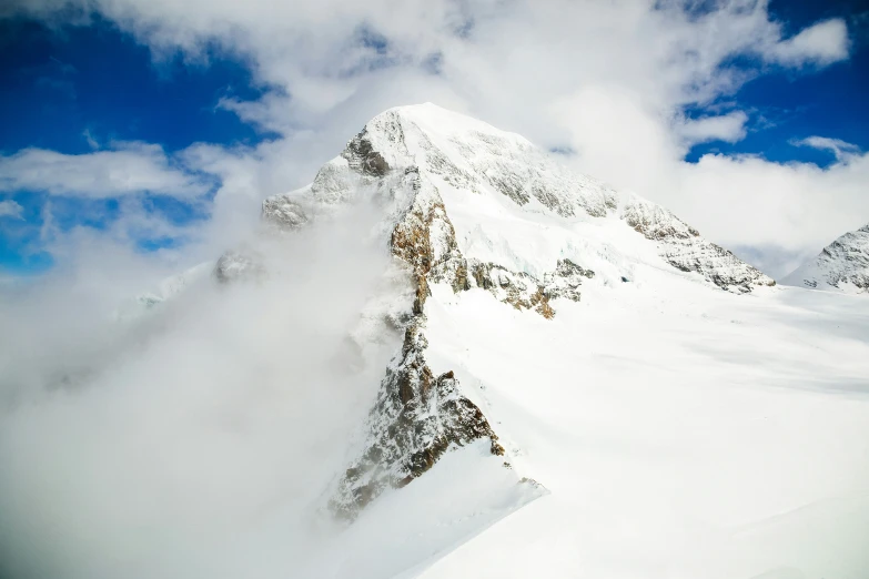 someone skiing down a very steep snowy mountain