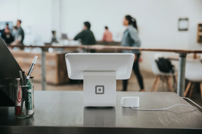 a white object sitting on top of a table next to a can of soda