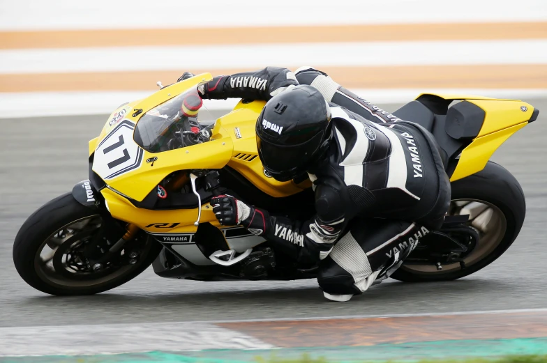 a person leaning into a motorcycle on a race track