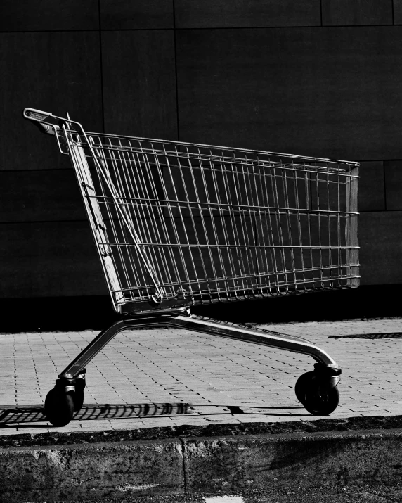 an empty shopping cart on a sidewalk