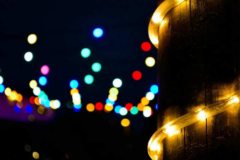 many lights shine brightly on the side of a wooden post