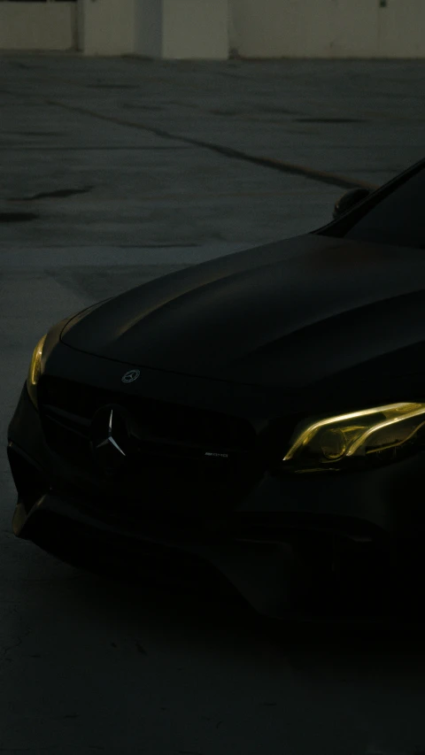 a car parked on top of a parking lot with its hood covered in gold paint