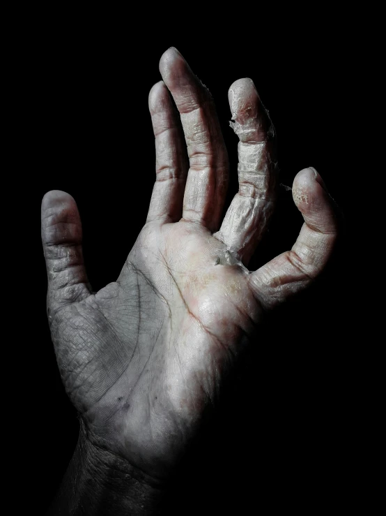 a hand is painted white with soing dark