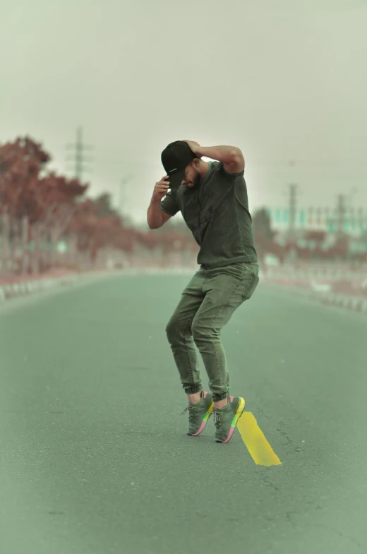 man standing on skate board talking on cell phone