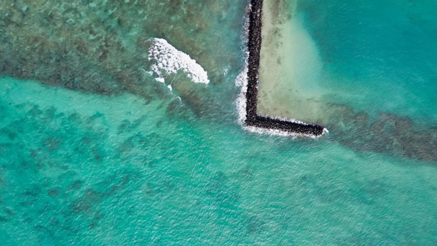 the aerial view of an ocean with ice on it