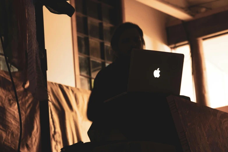 an image of a man working on his apple laptop