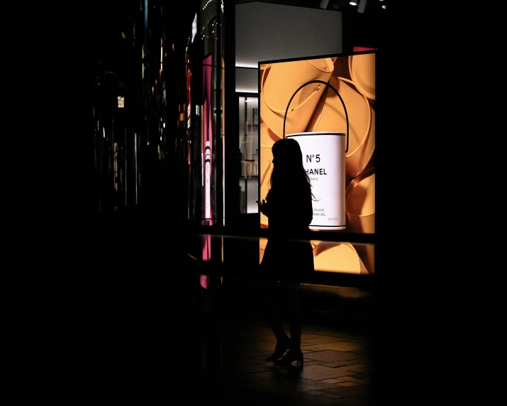 a woman stands in front of a display case that contains a spiral design