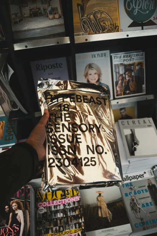 a hand is holding up an advertit in a store