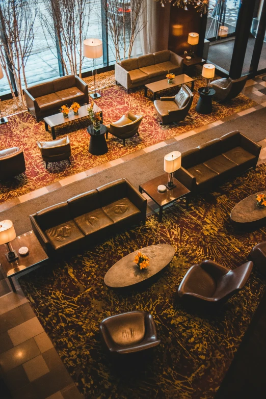 an empty lobby has some flower arrangements and candleholders