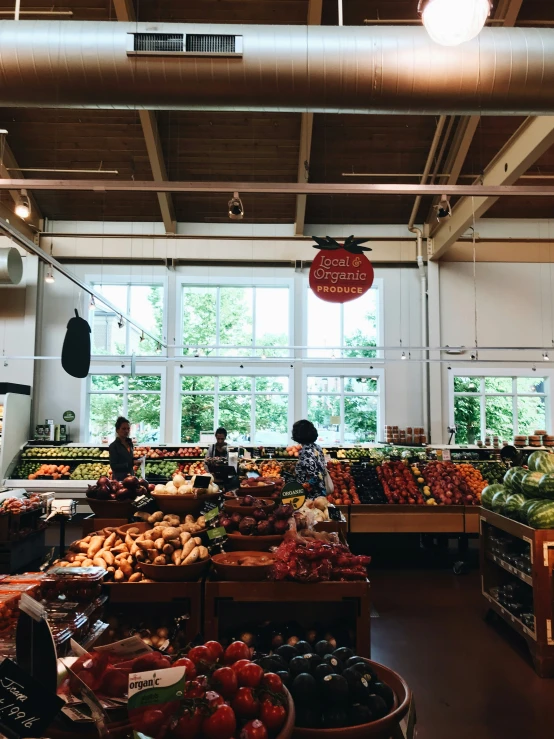 many fruits and vegetables are on display in a large open - air market