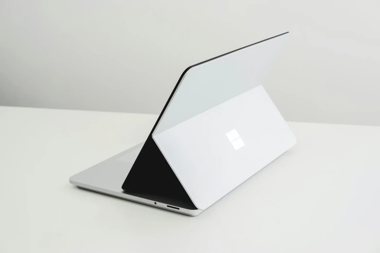 a laptop computer that is turned on a white surface