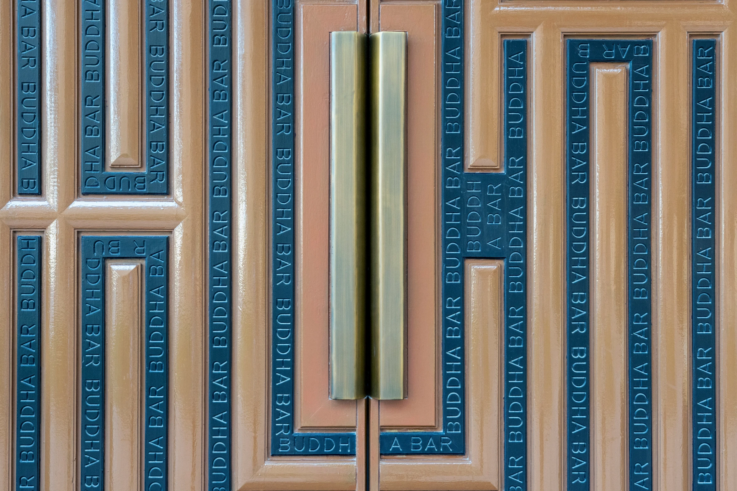 a wooden door is adorned with metal designs