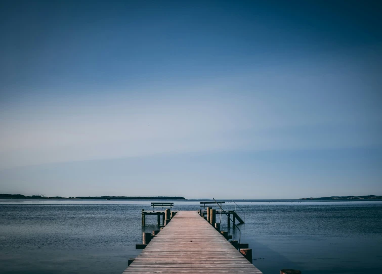 the end of a dock leading out to the water