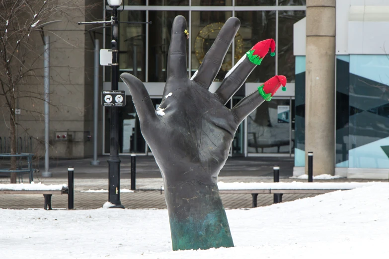 a hand statue with three roses sticking out of it