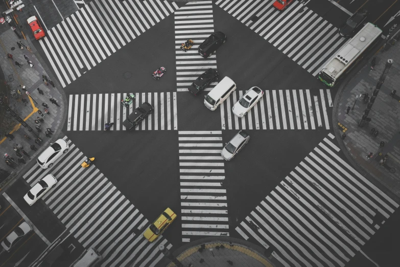 a cross walk, intersection with a yellow cab