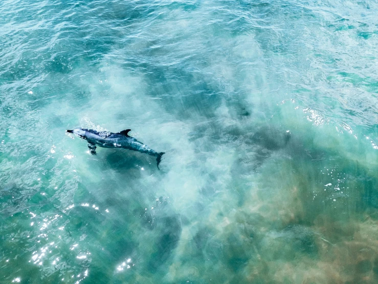 an airplane is on the water in the middle of blue waves